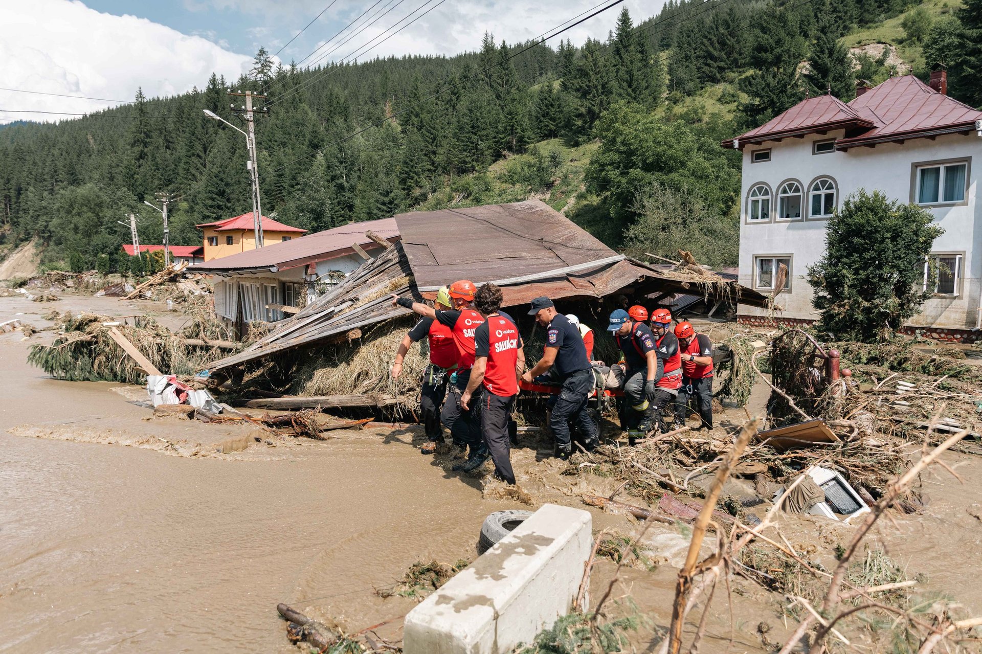 Rescue teams evacuating residents from flood-damaged area