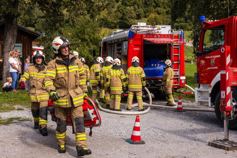 Firefighters in protective gear engaged in emergency response training