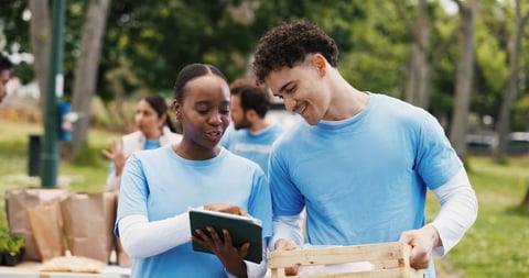Volunteers with tablet conducting inventory and donations outdoors