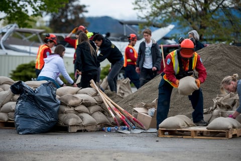 Emergency response worker with sandbags